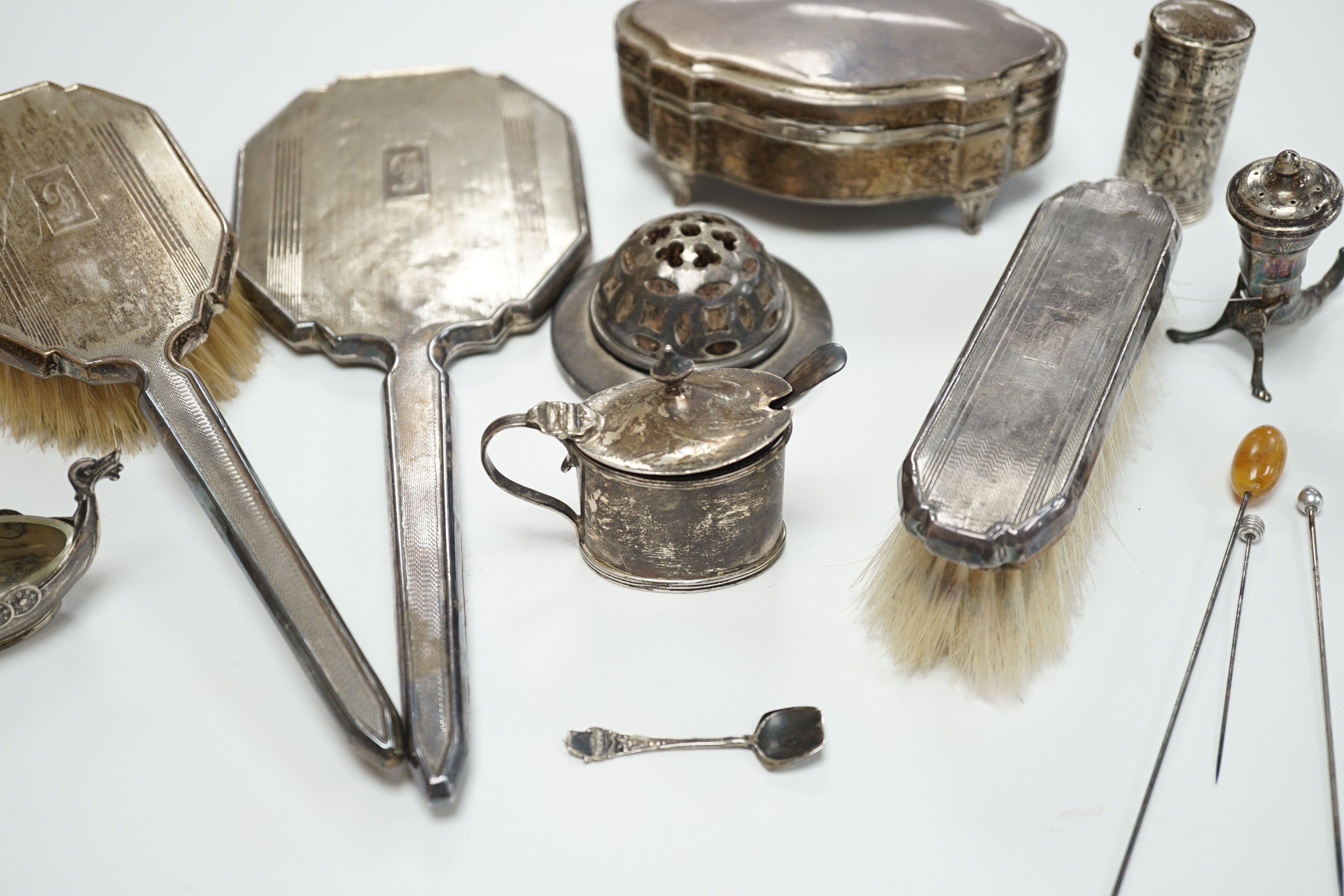 A George V silver mounted trinket box, Elkington & Co, Birmingham, 1918, 13.1cm, a silver mustard pot, two Scandinavian 925 condiments, two silver mounted scent bottles, hatpins and hatpin stand and a silver mounted thre